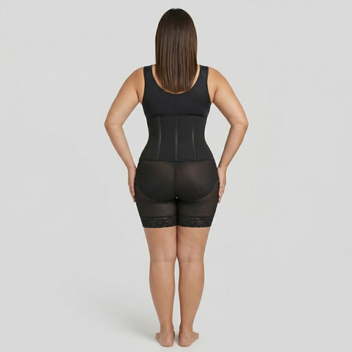 Person wearing a black shapewear garment on a plain background