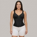 Woman wearing a black waist trainer with a zipper on a gray background